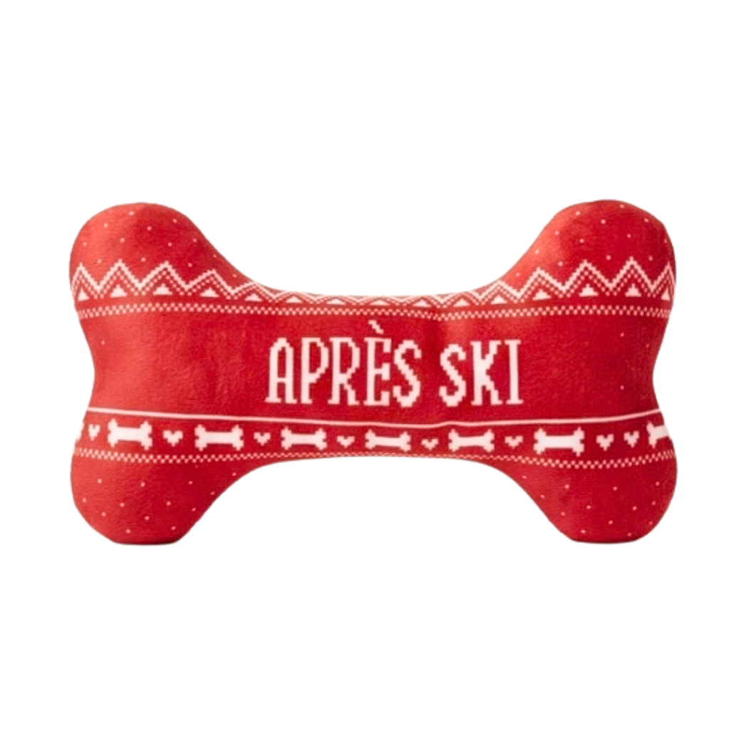 Coco & Pud - Apres Ski bone-shaped red plush dog toy with white knit-style patterns and the text 'APRÈS SKI' in the centre - Haute Diggity Dog