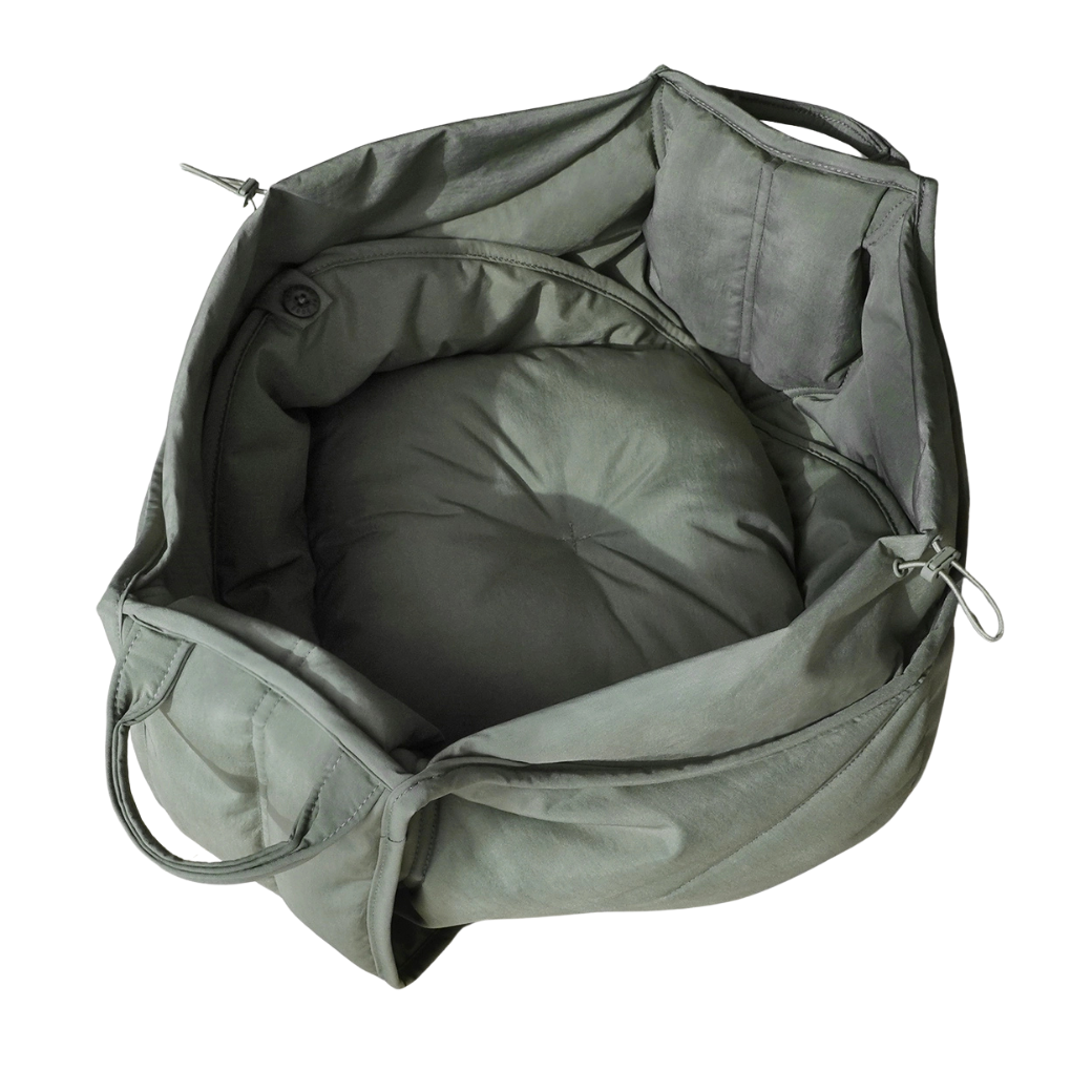 Coco & Pud - Olla soft pet carrier in olive green shown open, revealing a circular padded cushion inside - Lambwolf Collective