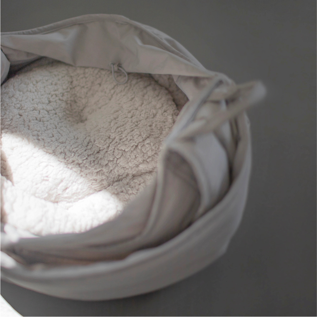 Coco & Pud - Olla soft pet carrier in Koala colour shown open, revealing a reversible circular padded cushion inside - Lambwolf Collective