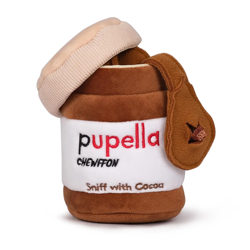 Coco & Pud Pupella is an interactive plush toy shaped like a Pupella jar, with a beige lid, brown body, and a white label reading 'pupella' and 'Sniff with Cocoa' - Chewffon