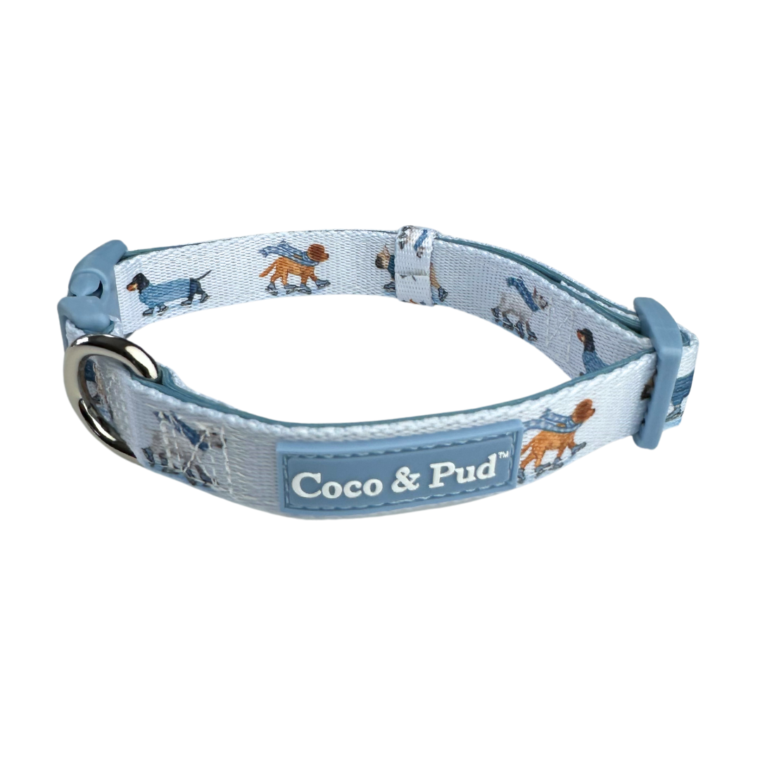 Coco & Pud Skating Dogs dog collar. A light blue dog collar with a repeating pattern of dachshunds in different poses, featuring the 'Coco & Pud' brand