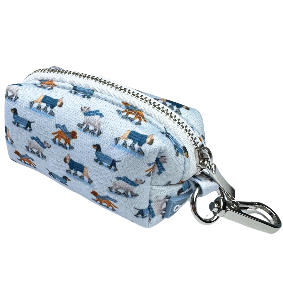 Coco & Pud Skating Dogs waste bag holder. A light blue dog collar with a repeating pattern of dachshunds in different poses, featuring the 'Coco & Pud' brand