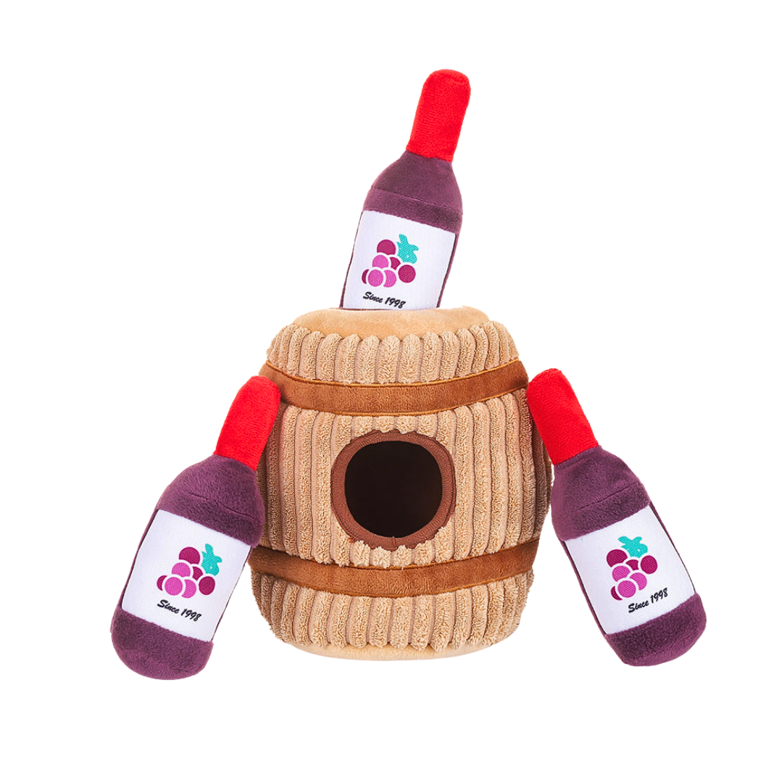 Coco & Pud Wine Barrel Interactive plush dog toy -with wine bottles near it Hugsmart