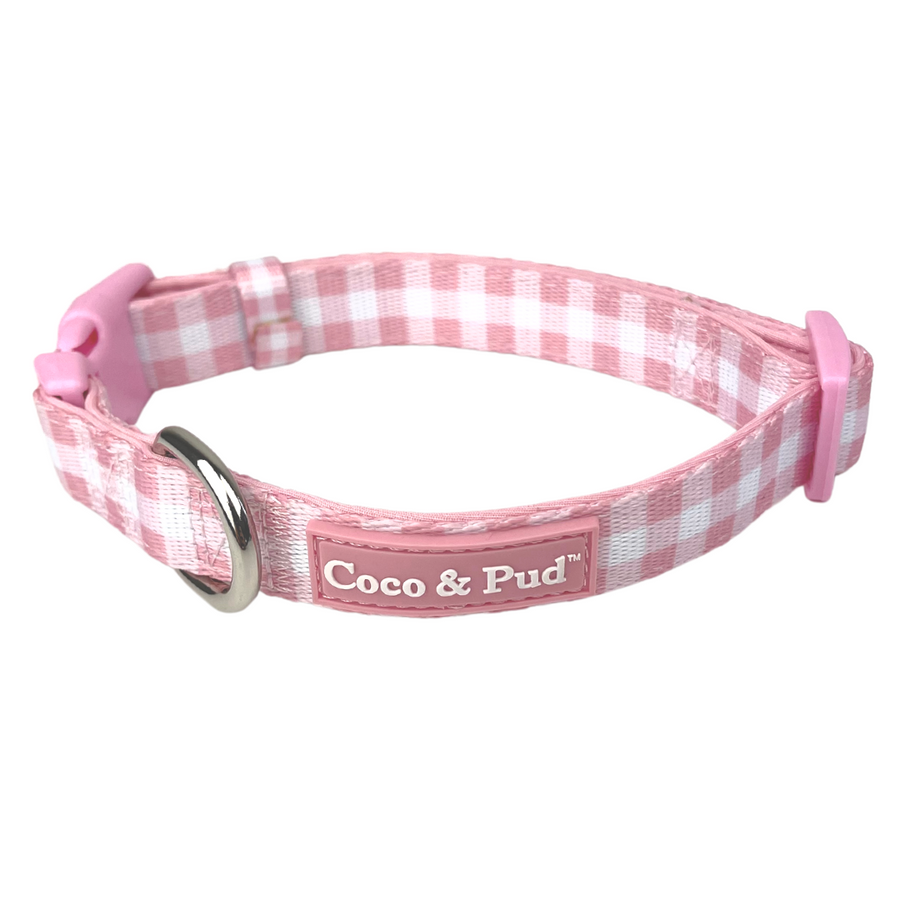 Coco & Pud- Gingham Rose Dog Collar, a pink and white gingham check dog collar with a silver metal ring and a pink brand label reading 'Coco & Pud'.