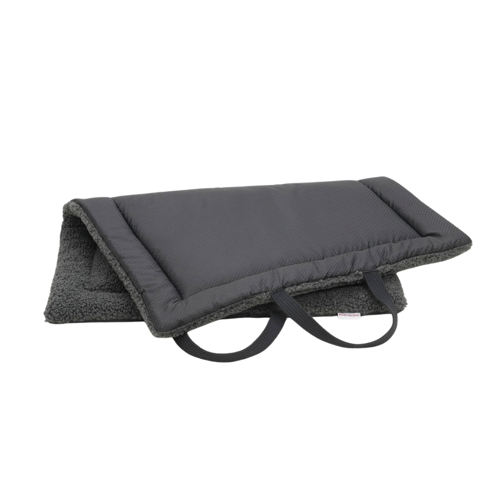 Coco & Pud - Matti Luxury Dog Travel Mat. A dark grey padded travel mat for dogs with a textured non-slip base material, plush fleece lining, and black carrying handles - Dogs in the City