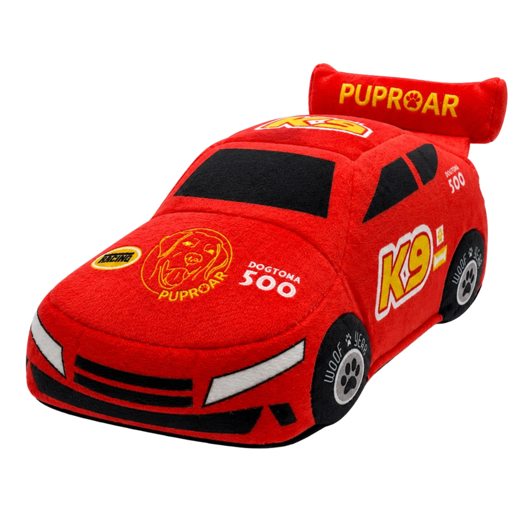 Coco & Pud - Stock Car Racing Car plush dog toy. Red plush toy car with racing graphics, including 'PUPROAR' on the spoiler and hood, 'K9' on the side, and 'DOGTONA 500' on the front - Puproar