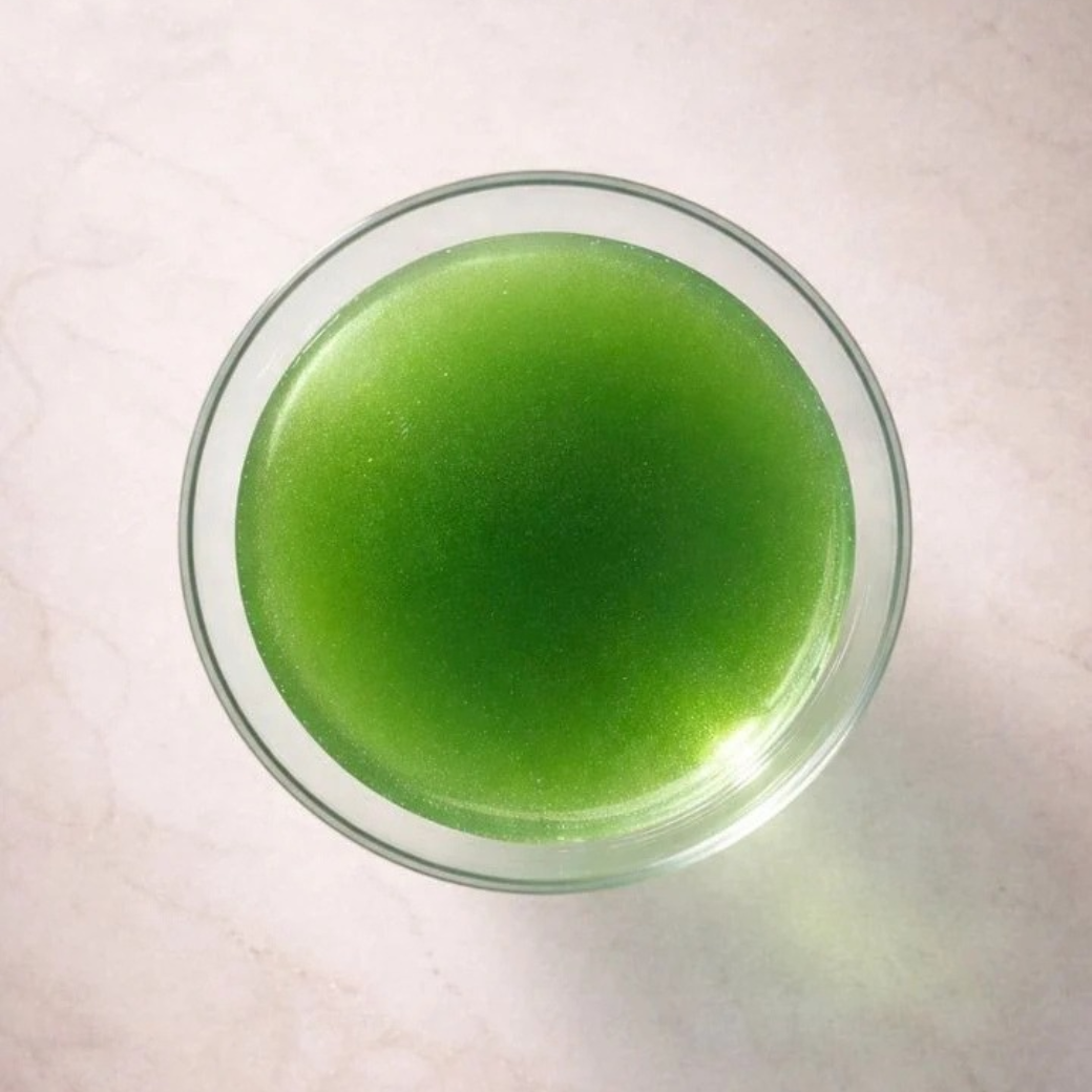 Coco & Pud - Muttini dog tonic top-down view of a clear glass bowl filled with bright green dog tonic - Puptail Society