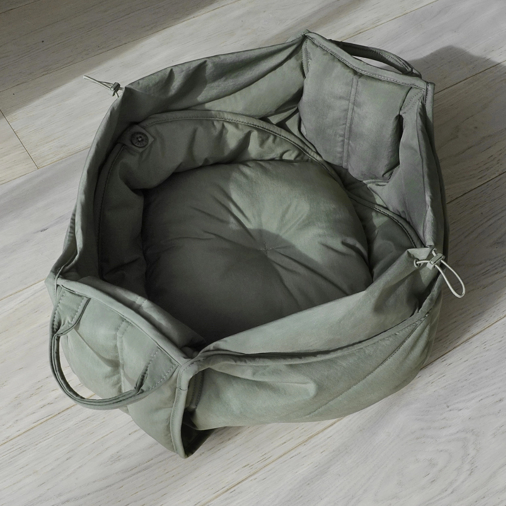 Coco & Pud - Olla soft pet carrier in olive green shown open, revealing a reversible circular padded cushion inside - Lambwolf Collective