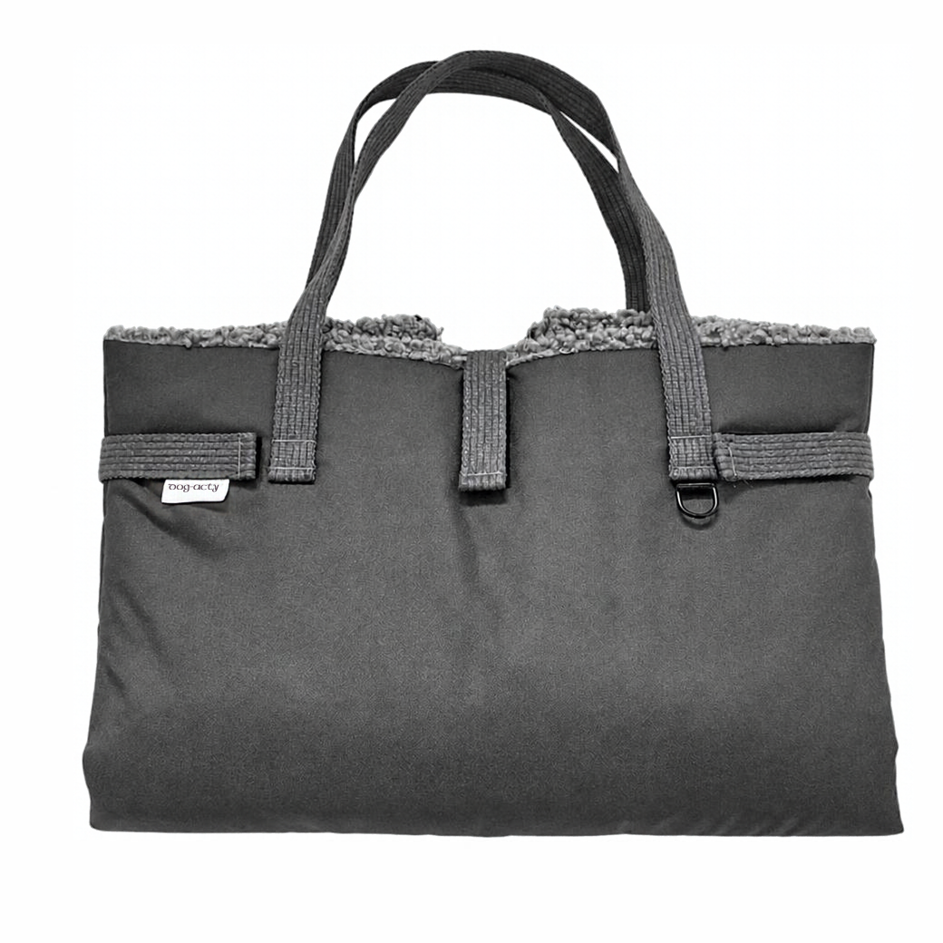 Coco & Pud - Matti Luxury Dog Travel Mat in Graphite. A dark grey folded travel mat bag with a grey sherpa faux-fur lining visible at the top, dual top handles-  Dogs in The City.
