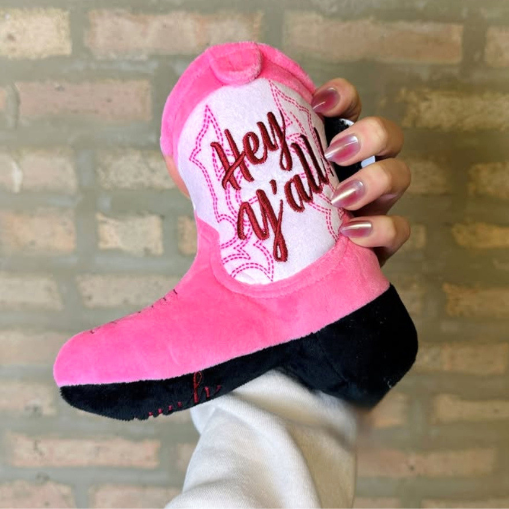 Coco & Pud Pink Cowgirl Boot being held against a rustic brick all - Haute Diggity Dog