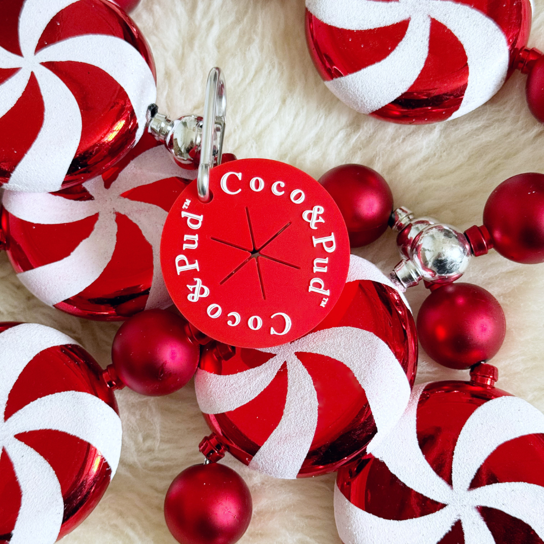 Red and white Christmas ornaments with a 'Coco & Pud' Poop Bag Carrier - Red 